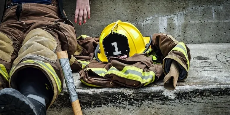 Firefighter gear on concrete steps.