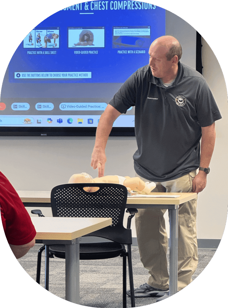 Instructor demonstrating CPR techniques on a dummy.